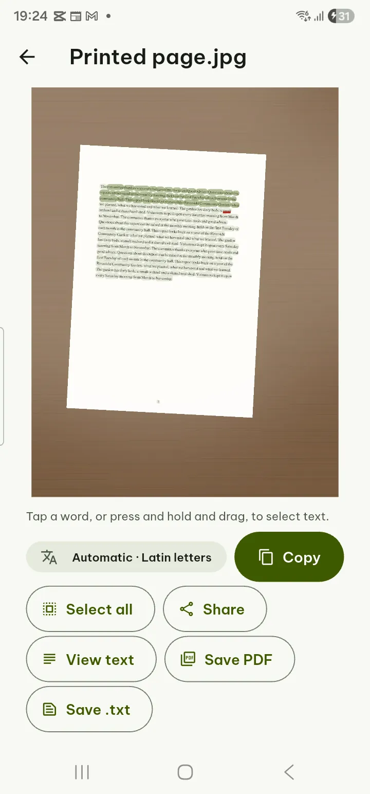 Recognized text selected over a photo of a printed page, with Copy all and Save buttons
